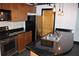 Modern kitchen featuring stainless steel appliances, wood cabinets, and black granite countertops at 319 Atlanta Se St # 317, Marietta, GA 30060