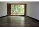 Bright living room featuring a large window with wooded view and brick accent wall at 319 Atlanta Se St # 317, Marietta, GA 30060