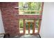 Living room has brick wall and large windows with wooded view at 319 Atlanta Se St # 317, Marietta, GA 30060