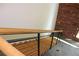 Modern staircase features wood treads, metal railings, and an accent brick wall at 319 Atlanta Se St # 317, Marietta, GA 30060