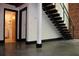 Modern staircase with open treads, black metal railings, and polished concrete floors at 319 Atlanta Se St # 317, Marietta, GA 30060