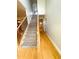 View of entryway with wood floors, staircase, and wrought iron banister at 325 Brook Hollow Ln, Loganville, GA 30052