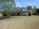 Charming two-story home with a spacious front yard and inviting front porch at 325 Brook Hollow Ln, Loganville, GA 30052