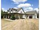 Charming two-story home with a spacious yard, inviting porch, and manicured landscaping at 325 Brook Hollow Ln, Loganville, GA 30052