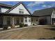Inviting home exterior with stone pillars, a walkway, and manicured landscaping at 325 Brook Hollow Ln, Loganville, GA 30052