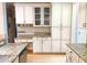 Spacious kitchen featuring granite countertops, white cabinets, stainless steel appliances, and bonus desk space at 325 Brook Hollow Ln, Loganville, GA 30052