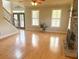 Bright living room with hardwood floors, stone fireplace, and an abundance of natural light at 325 Brook Hollow Ln, Loganville, GA 30052