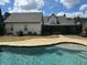 Relaxing backyard with a sparkling pool, screened porch, and lush greenery at 325 Brook Hollow Ln, Loganville, GA 30052