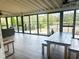 Open sunroom with dining and seating areas surrounded by walls of windows at 325 Brook Hollow Ln, Loganville, GA 30052