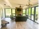 Inviting sunroom with stone fireplace, ceiling fan, and view of backyard at 325 Brook Hollow Ln, Loganville, GA 30052