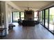 Bright sunroom featuring a stone fireplace, comfortable seating, and expansive windows at 325 Brook Hollow Ln, Loganville, GA 30052