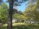 Expansive backyard featuring a detached garage, mature trees, and ample space for outdoor activities and relaxation at 579 Wexwood Dr, Riverdale, GA 30274