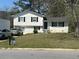 Charming two-story home featuring a manicured front lawn, classic black shutters, and convenient driveway parking at 579 Wexwood Dr, Riverdale, GA 30274