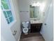 Bright bathroom with vanity, granite countertop, and wood-look flooring at 945 Navajo Trl, Covington, GA 30016