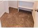 Walk-in closet featuring neutral carpet and shelving for optimized storage space at 945 Navajo Trl, Covington, GA 30016