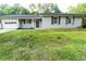 Charming single story home with light gray siding, black shutters and trim at 945 Navajo Trl, Covington, GA 30016