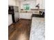 Modern kitchen with white cabinets, stainless appliances, and granite countertops at 945 Navajo Trl, Covington, GA 30016