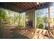 Unfinished deck area features a fireplace, exposed framing and a view of surrounding trees at 1430 Oconee Ne Pass, Brookhaven, GA 30319