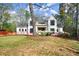 New home boasts modern design, black-trimmed windows, a manicured lawn, and blooming flowers at 1430 Oconee Ne Pass, Brookhaven, GA 30319