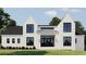 The front exterior of this modern white home features a sleek design, black windows, and manicured landscaping at 1430 Oconee Ne Pass, Brookhaven, GA 30319