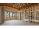Spacious unfinished living room framed with wooden beams and natural light pouring through multiple windows at 1430 Oconee Ne Pass, Brookhaven, GA 30319