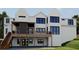 The back exterior features a modern design with deck, balconies, black windows, and yard at 1430 Oconee Ne Pass, Brookhaven, GA 30319