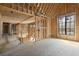 Bright, unfinished upstairs interior with exposed framing, large windows, and staircase shows open floorplan at 1430 Oconee Ne Pass, Brookhaven, GA 30319