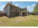 Spacious backyard with healthy grass and a charming two-story home, great for outdoor activities at 241 Haney Rd, Woodstock, GA 30188