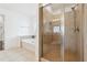 Bathroom featuring a soaking tub, a glass enclosed walk-in shower, and tile flooring throughout at 241 Haney Rd, Woodstock, GA 30188
