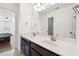 Bathroom featuring dual sinks, vanity and a mirror with views of the bedroom at 241 Haney Rd, Woodstock, GA 30188