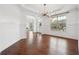 Formal dining room featuring hardwood floors, decorative chandelier, and large windows, perfect for entertaining at 241 Haney Rd, Woodstock, GA 30188