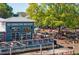 The Reformation Brewery features an outdoor seating area with picnic tables under mature trees at 241 Haney Rd, Woodstock, GA 30188