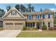 Charming brick home with a two-car garage and manicured front lawn, perfect for suburban living at 241 Haney Rd, Woodstock, GA 30188