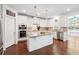Bright kitchen features stainless appliances, granite countertops, and a center island at 241 Haney Rd, Woodstock, GA 30188