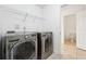 Convenient laundry room featuring modern appliances and access to a half bathroom at 241 Haney Rd, Woodstock, GA 30188