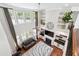 Lofted view of the living room, featuring a fireplace, built-ins, and tall windows at 241 Haney Rd, Woodstock, GA 30188