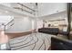 An expansive living room featuring a soaring ceiling, hardwood floors, an open staircase, and a seamless flow to the kitchen at 241 Haney Rd, Woodstock, GA 30188