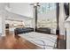 Bright, open living room with hardwood floors, a fireplace, and a seamless connection to a modern, white kitchen at 241 Haney Rd, Woodstock, GA 30188