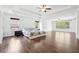 An oversized primary bedroom boasts natural light, hardwood floors, a tray ceiling, and ample open space at 241 Haney Rd, Woodstock, GA 30188