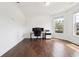 Well-lit home office with hardwood floors, offering a functional workspace with natural light at 241 Haney Rd, Woodstock, GA 30188