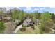 An aerial view of a home surrounded by lush trees on a verdant lot at 383 Indian Hills Trl, Marietta, GA 30068