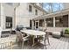 Large backyard deck featuring a dining table, comfortable seating, and stylish string lights at 383 Indian Hills Trl, Marietta, GA 30068