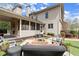 Beautiful backyard with a screened porch, brick fireplace, fire pit, and comfortable seating, ideal for outdoor relaxation at 383 Indian Hills Trl, Marietta, GA 30068