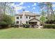 Spacious backyard featuring a well-manicured lawn, mature trees, and a cozy covered porch at 383 Indian Hills Trl, Marietta, GA 30068