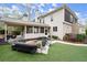 Serene backyard featuring a screened porch, outdoor fireplace, fire pit, and manicured lawn for outdoor enjoyment at 383 Indian Hills Trl, Marietta, GA 30068
