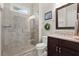 Modern bathroom with tiled glass shower, stylish vanity, and a framed mirror at 383 Indian Hills Trl, Marietta, GA 30068