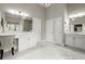 Bright bathroom featuring double sinks, white cabinets, and a vanity area with ample counter space at 383 Indian Hills Trl, Marietta, GA 30068