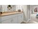Bathroom with double vanity, warm countertop, and decorative elements adding charm to the space at 383 Indian Hills Trl, Marietta, GA 30068