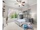 This bedroom features a bunk bed, hanging chair, and a large window with beautiful natural light at 383 Indian Hills Trl, Marietta, GA 30068