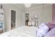 Bedroom featuring a decorative light fixture, comfortable bed, desk and doorway to a half bathroom at 383 Indian Hills Trl, Marietta, GA 30068